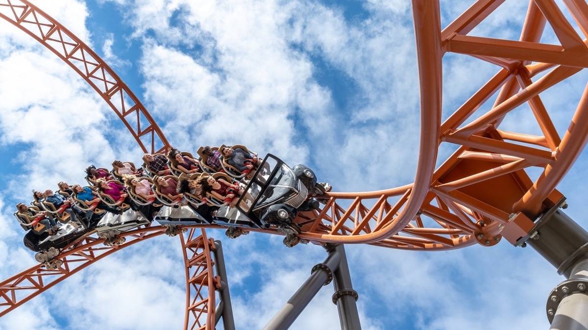 View looking up at a roller coaster as people ride it at Carowinds